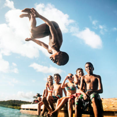 Kids playing in the ocean.